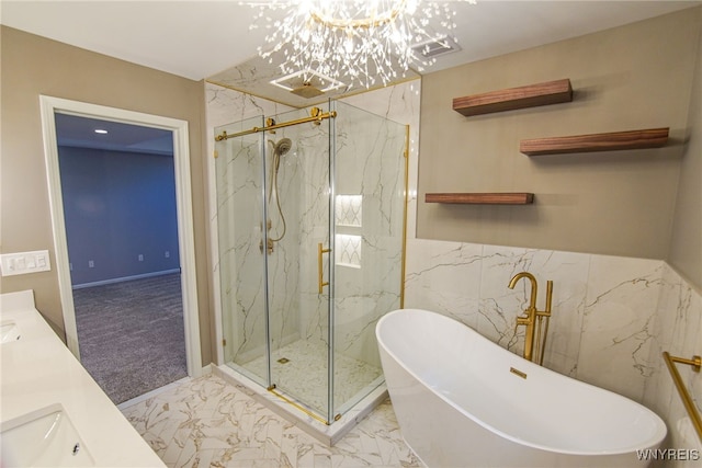 bathroom with shower with separate bathtub, an inviting chandelier, and vanity