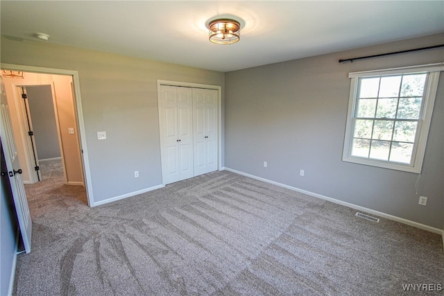 unfurnished bedroom with a closet and carpet floors