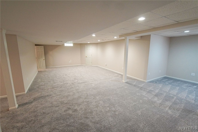 basement with carpet and a drop ceiling