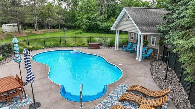 view of pool with a yard and a patio area