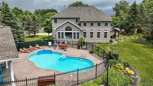 back of house featuring a fenced in pool, a patio area, and a yard