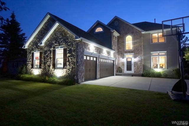 view of front of house with a garage and a lawn