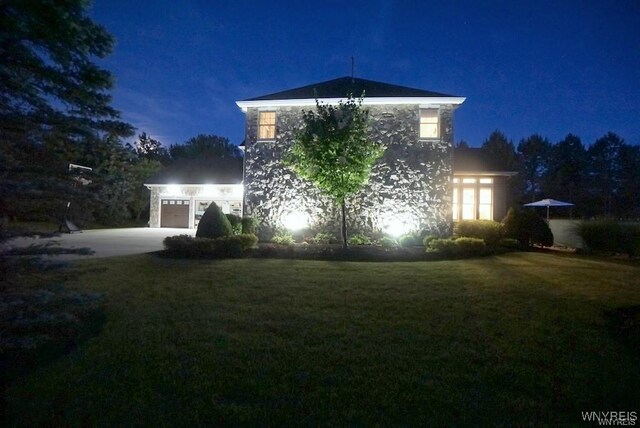 back house at night with a yard