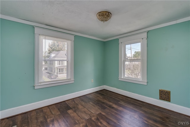 unfurnished room with crown molding and dark hardwood / wood-style floors