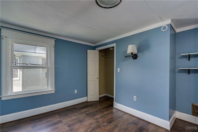 unfurnished room featuring dark hardwood / wood-style flooring and ornamental molding