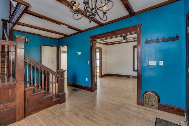 foyer entrance with light hardwood / wood-style flooring, beamed ceiling, and ceiling fan with notable chandelier