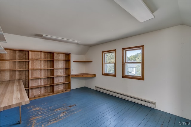 interior space with a baseboard radiator, vaulted ceiling, and wood-type flooring