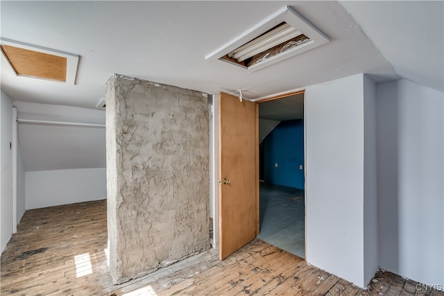 interior space featuring lofted ceiling and light hardwood / wood-style flooring