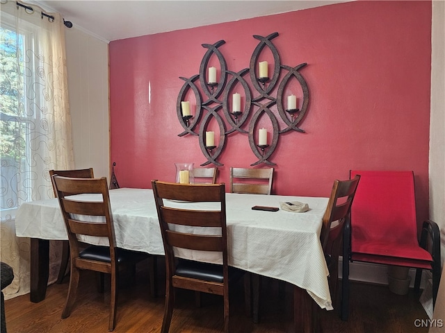 dining space with dark hardwood / wood-style flooring