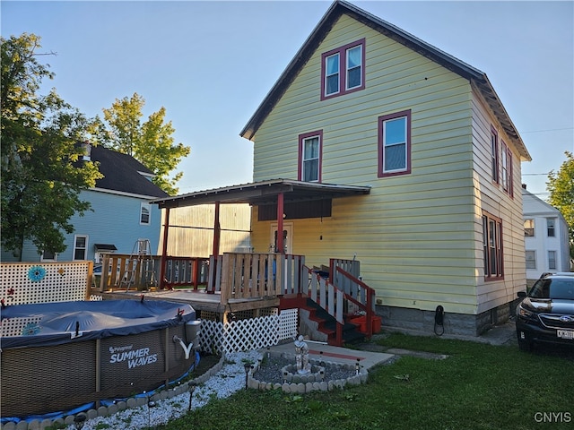 back of house featuring a wooden deck