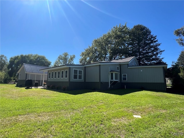 back of house with a lawn