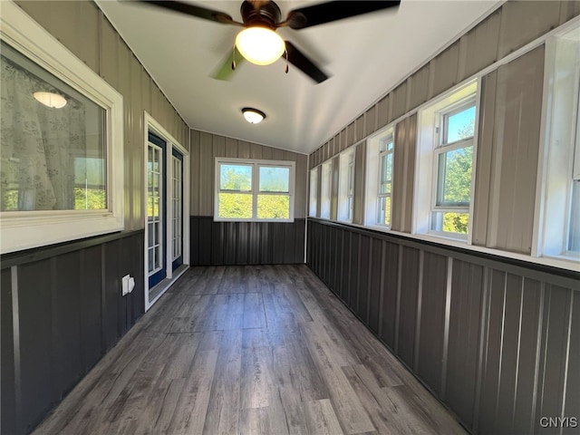 unfurnished sunroom with ceiling fan and vaulted ceiling