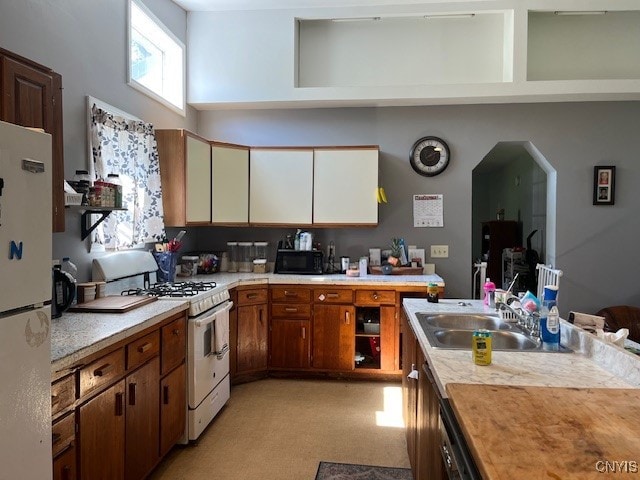 kitchen featuring sink and white appliances