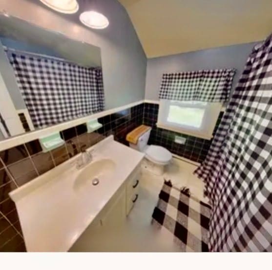 bathroom featuring tile walls, tile patterned flooring, vanity, and toilet