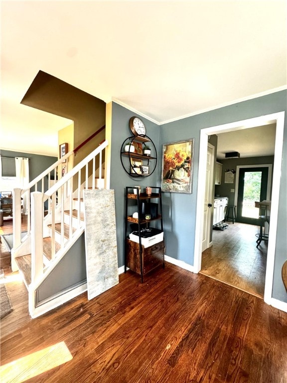 interior space with hardwood / wood-style flooring and crown molding