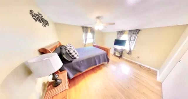 bedroom with ceiling fan and hardwood / wood-style flooring