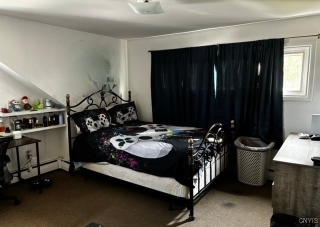 carpeted bedroom with a baseboard heating unit