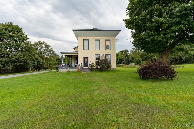 view of front of home with covered porch and a front yard