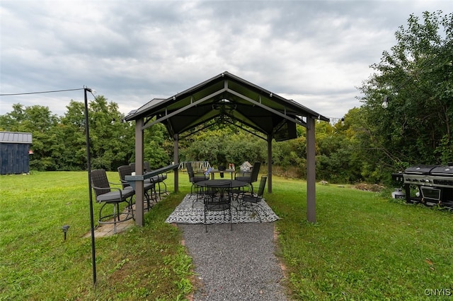 view of community with a lawn, a patio, and a gazebo