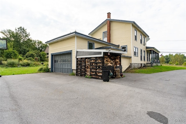 view of side of home featuring a yard and a garage