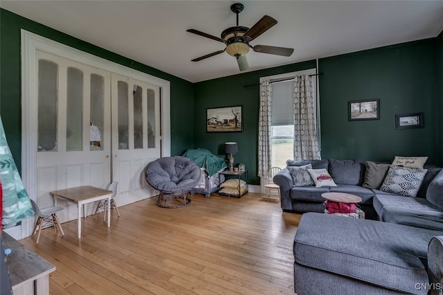 living room featuring ceiling fan and light hardwood / wood-style floors