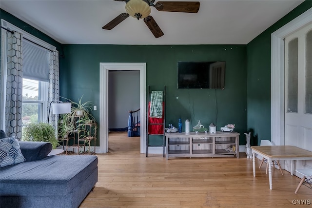 living room featuring light wood-type flooring and ceiling fan