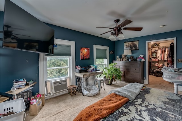 bedroom featuring cooling unit, ceiling fan, a closet, carpet flooring, and a spacious closet