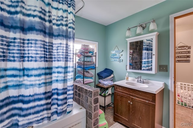 bathroom with tile patterned flooring, shower / bathtub combination with curtain, and vanity