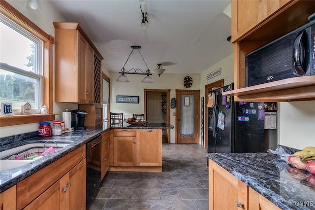 kitchen featuring pendant lighting, black appliances, kitchen peninsula, dark stone counters, and track lighting