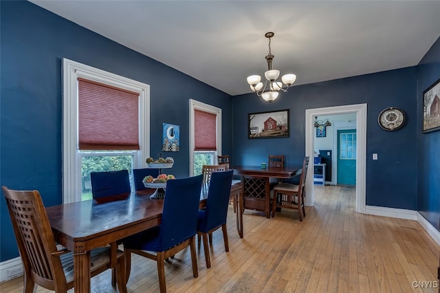 dining room featuring a chandelier and light hardwood / wood-style floors