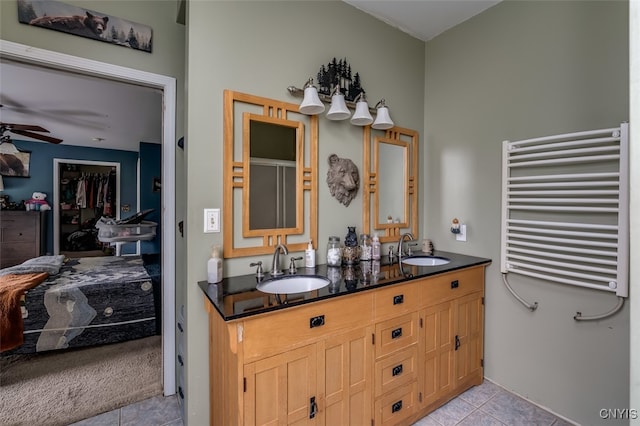 bathroom featuring tile patterned flooring, vanity, ceiling fan, and radiator heating unit