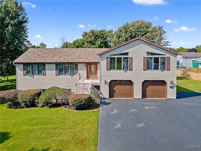 view of front of property with a garage and a front lawn