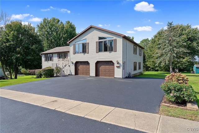 split level home featuring a front yard and a garage