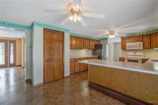 kitchen with ceiling fan, decorative backsplash, white appliances, and kitchen peninsula