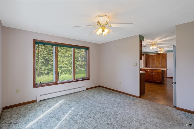 unfurnished room featuring ceiling fan and baseboard heating