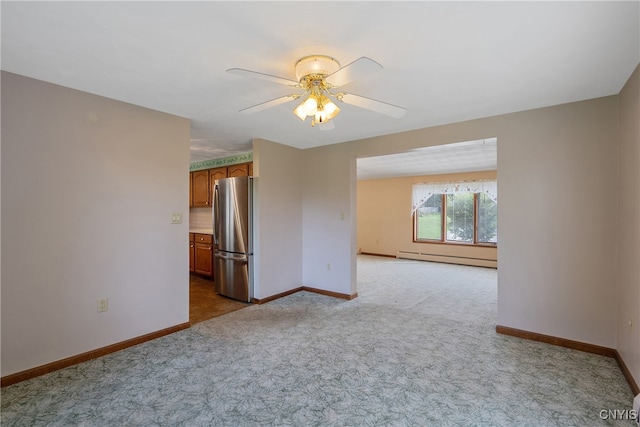 spare room featuring a baseboard heating unit, ceiling fan, and carpet floors