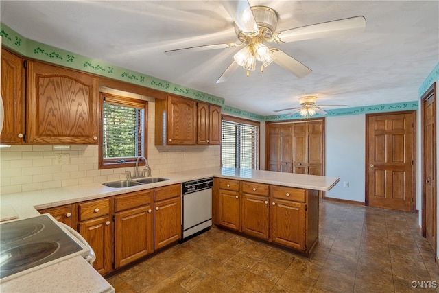 kitchen featuring white dishwasher, ceiling fan, a wealth of natural light, and sink