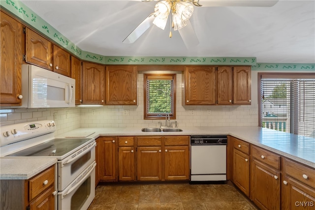 kitchen with white appliances, backsplash, sink, and ceiling fan