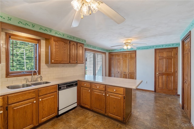 kitchen featuring white dishwasher, tasteful backsplash, kitchen peninsula, sink, and ceiling fan