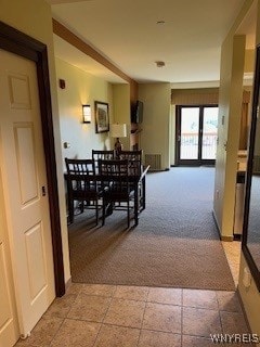 dining room featuring light carpet