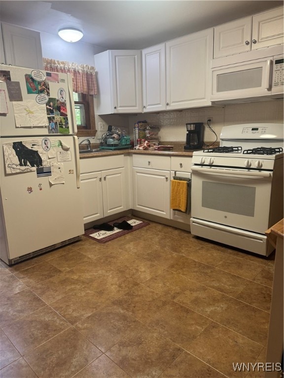 kitchen with backsplash, sink, white cabinets, and white appliances