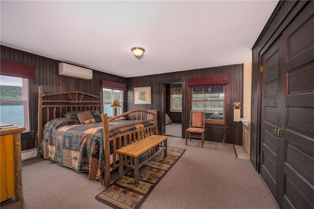 carpeted bedroom with an AC wall unit and wooden walls