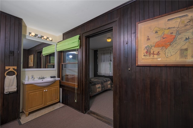 bathroom featuring wood walls and vanity