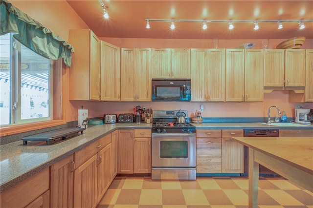 kitchen featuring rail lighting, dishwashing machine, light brown cabinets, sink, and stainless steel range with gas stovetop