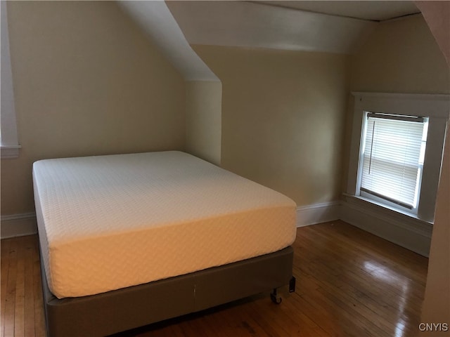 bedroom featuring hardwood / wood-style flooring and vaulted ceiling