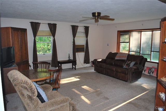 carpeted living room with a textured ceiling, a healthy amount of sunlight, and ceiling fan