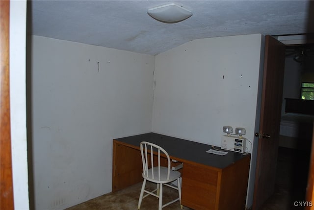 home office with a textured ceiling, carpet floors, and lofted ceiling