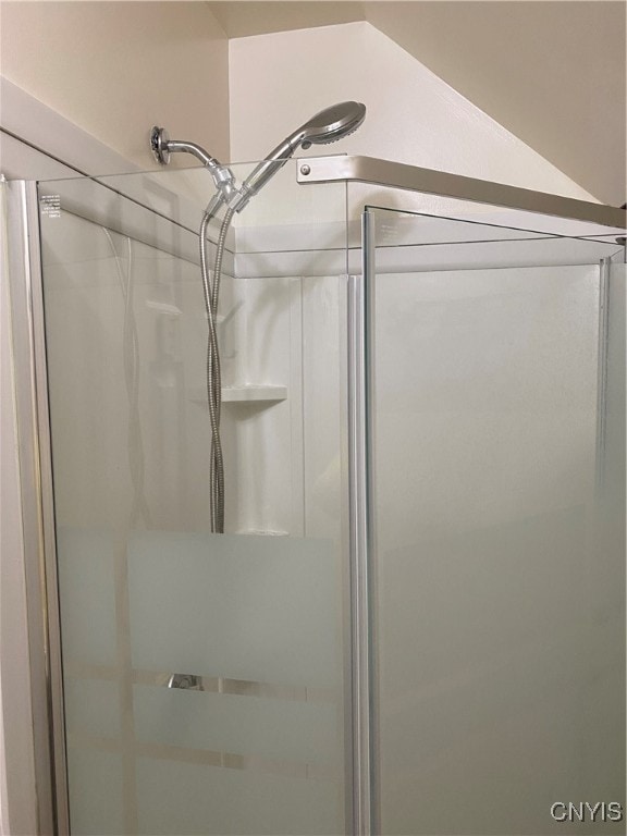 bathroom featuring a shower with shower door