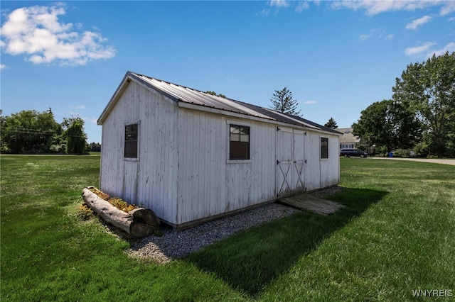 view of outbuilding featuring a lawn