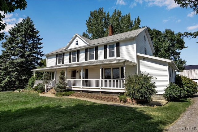 farmhouse-style home featuring covered porch and a front yard